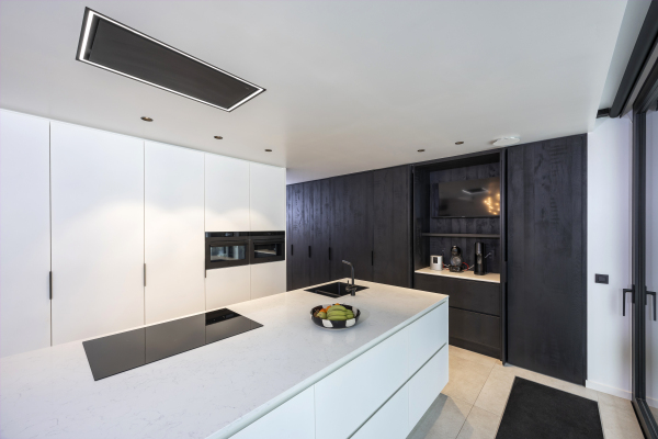 Keuken in witte poederlak en zwarte houtkleur. Werkblad van Articom in kleur Carrara Venato.